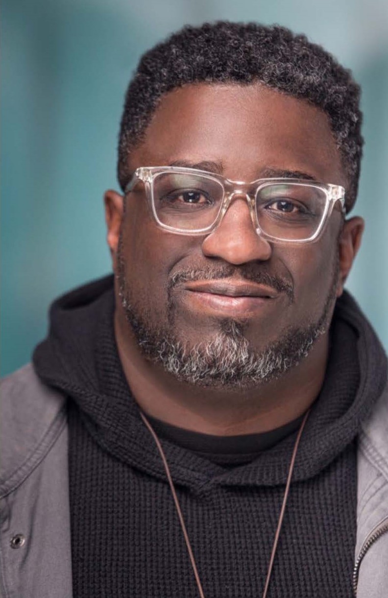 Lamar Hardwick is a middle-aged black man with a trim black & gray beard and glasses.