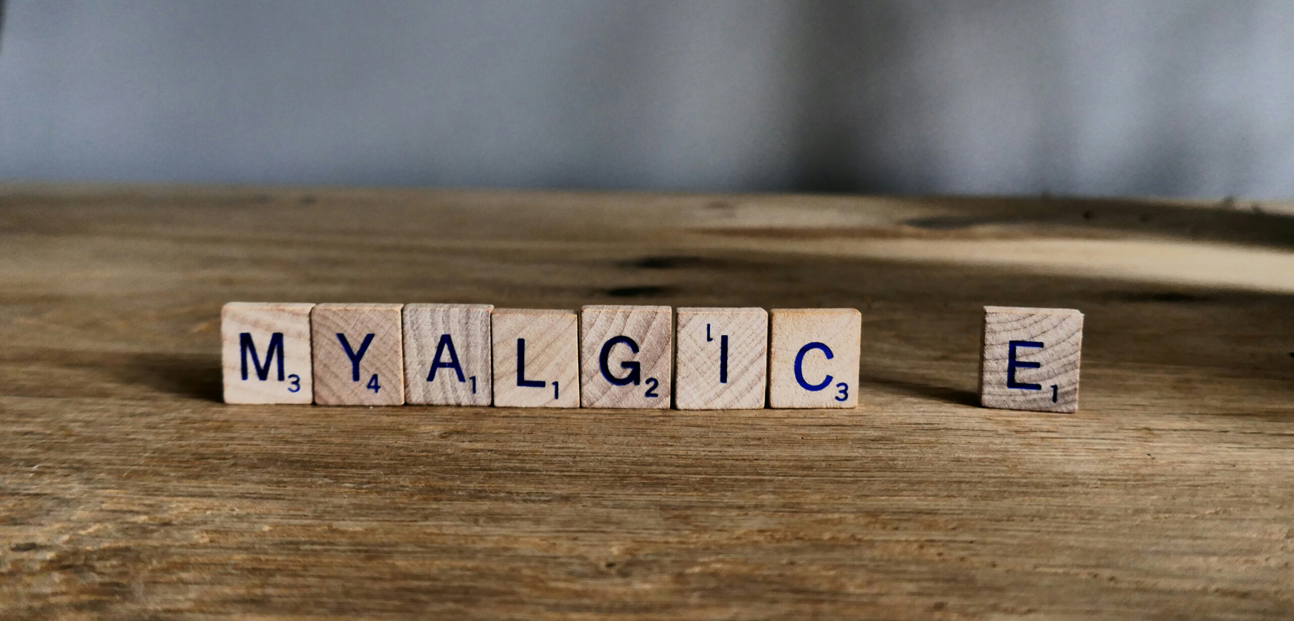 Myalgic E spelled out with wooden Scrabble tiles