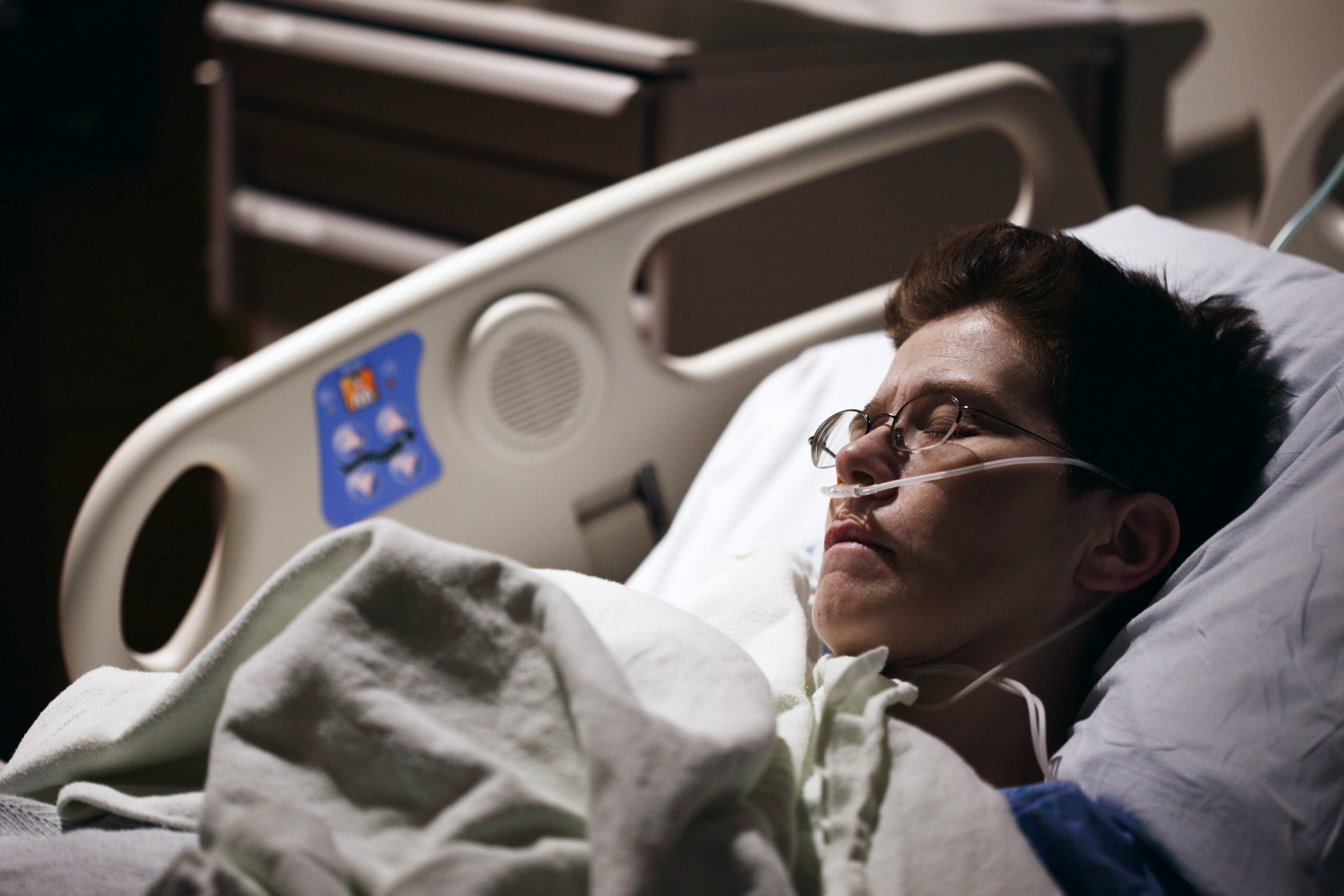 Man with brown hair in a hospital bed