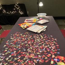 photo of a table with a puzzle and coloring books
