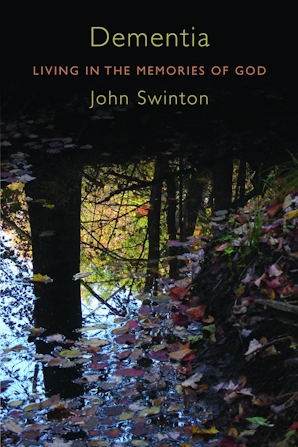 book cover of dementia with a photo of a reflection in water of trees with autumn leaves in shades of red and yellow falling into the water