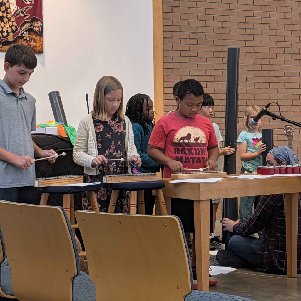 children playing instruments in a sanctuary