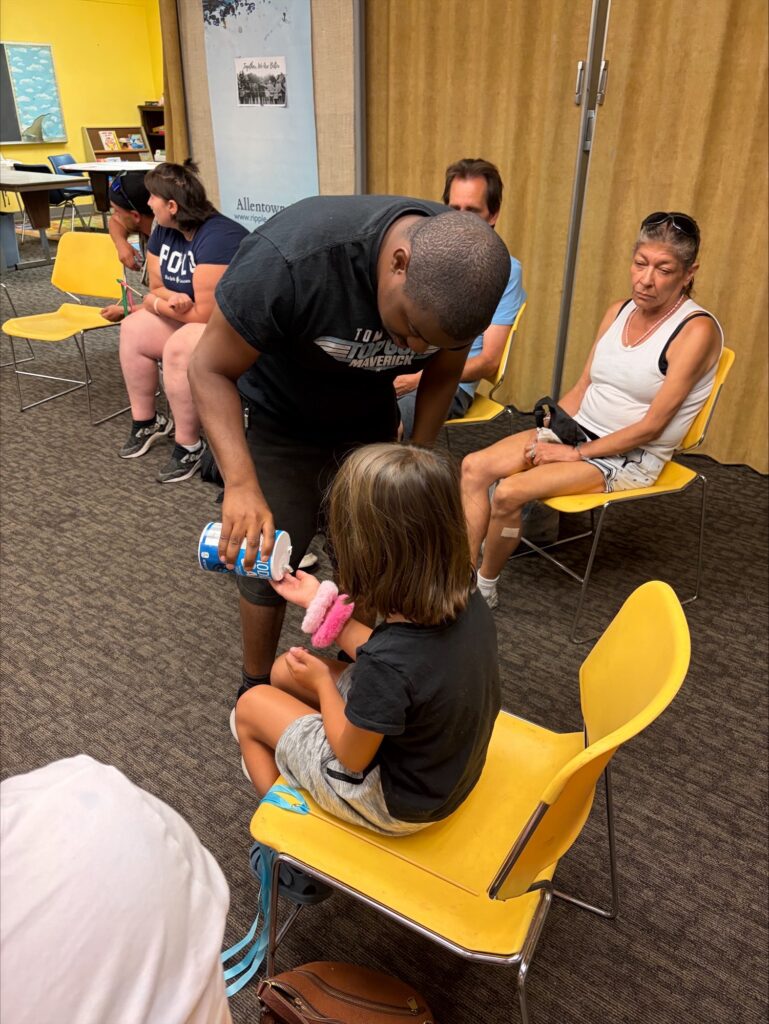 a man passes out salt to a child during worship